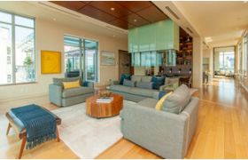 Furnished 3-bedroom condo with hardwood floors, modern decor, and city views.