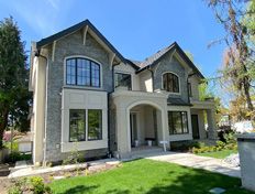 Spacious 4-bedroom duplex with large windows and a welcoming front porch.
