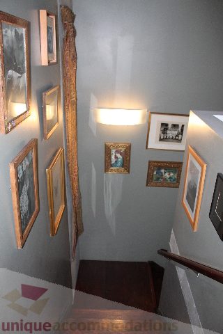 Staircase with framed artwork and wall sconce lighting. - 627 - 289 Alexander Street, Vancouver Downtown