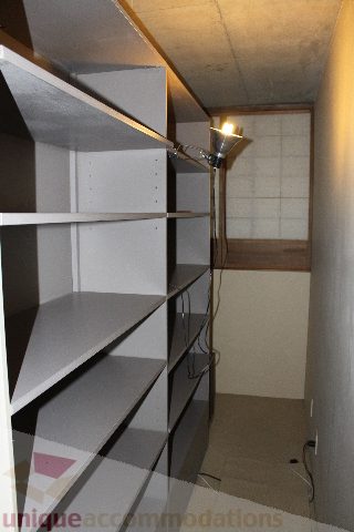 Furnished den with built-in shelves and a floor lamp. - 627 - 289 Alexander Street, Vancouver Downtown
