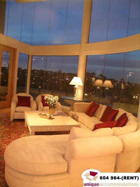 Furnished living room with large windows, city view, and plush seating. - 700 - 1888 York Ave, Vancouver West Side