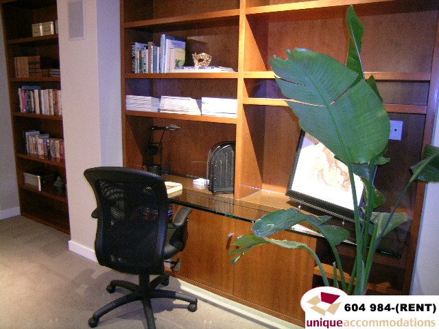 Furnished office with wooden shelves, desk, and black office chair. - 700 - 1888 York Ave, Vancouver West Side