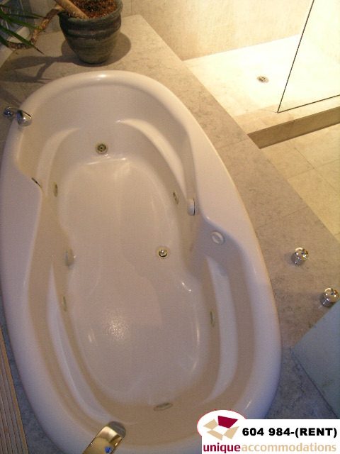 Furnished 2-bedroom + den condo with a modern bathtub and marble countertops. - 700 - 1888 York Ave, Vancouver West Side