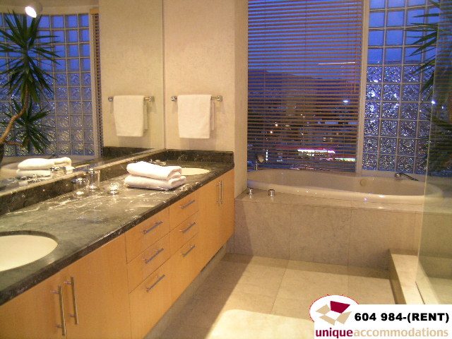 Furnished bathroom with granite countertops and city view. - 700 - 1888 York Ave, Vancouver West Side