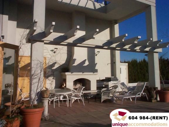 Furnished patio with outdoor seating, fireplace, and pergola. - 700 - 1888 York Ave, Vancouver West Side