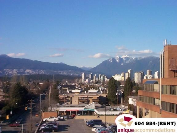Bright living room with city view and modern furnishings. - 700 - 1888 York Ave, Vancouver West Side