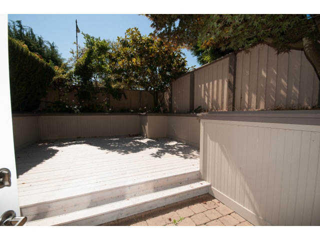 Bright deck with wooden steps and privacy fence, surrounded by trees. - 1881, Vancouver West Side
