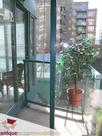Bright balcony with a potted plant and city view. - 509 - 939  Homer Street, Vancouver Downtown