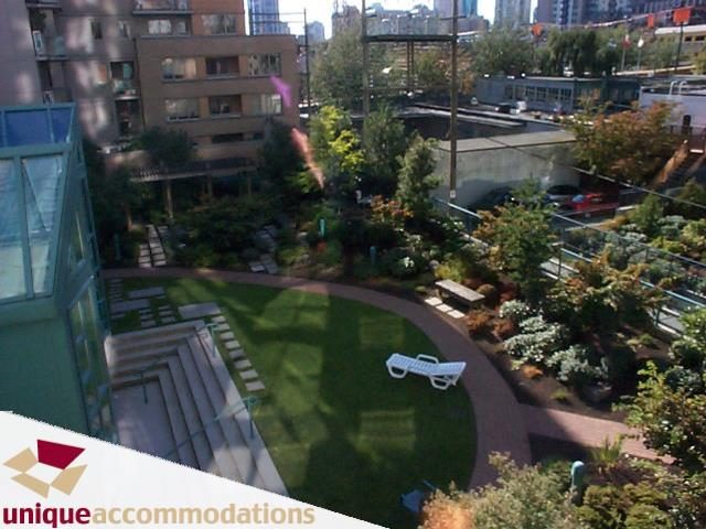 Furnished living room with city view and outdoor garden access. - 509 - 939  Homer Street, Vancouver Downtown