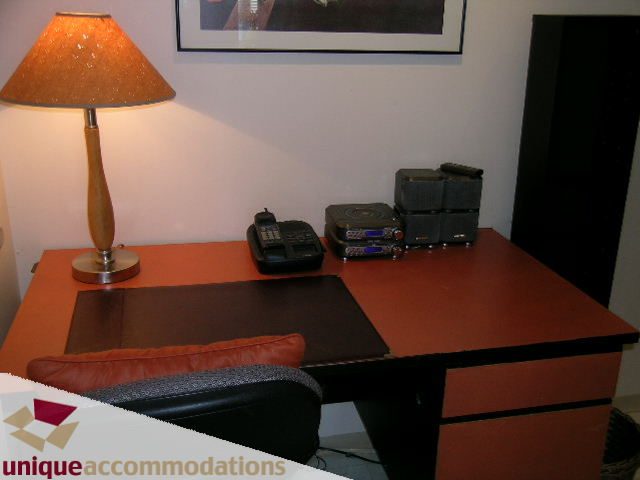 Furnished living space with a desk, lamp, and leather seating. - 509 - 939  Homer Street, Vancouver Downtown