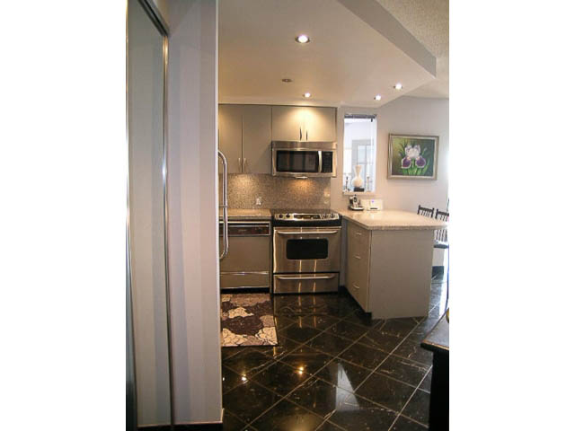 Bright kitchen with granite countertops and black tile flooring. - 1402 - 1625 Hornby, Vancouver Downtown