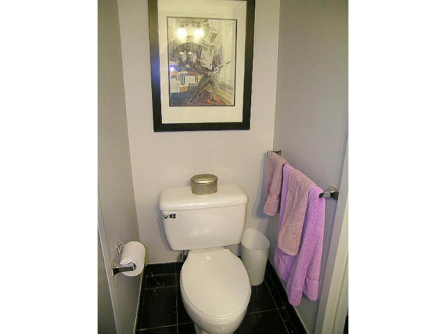 Bright bathroom with purple towels and black tile floor. - 1402 - 1625 Hornby, Vancouver Downtown
