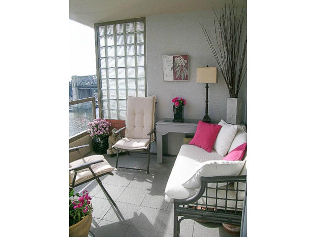 Bright living room with city view, modern furniture, and a glass block wall. - 1402 - 1625 Hornby, Vancouver Downtown