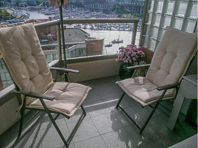 Furnished balcony with city view, comfortable chairs, and flowers. - 1402 - 1625 Hornby, Vancouver Downtown