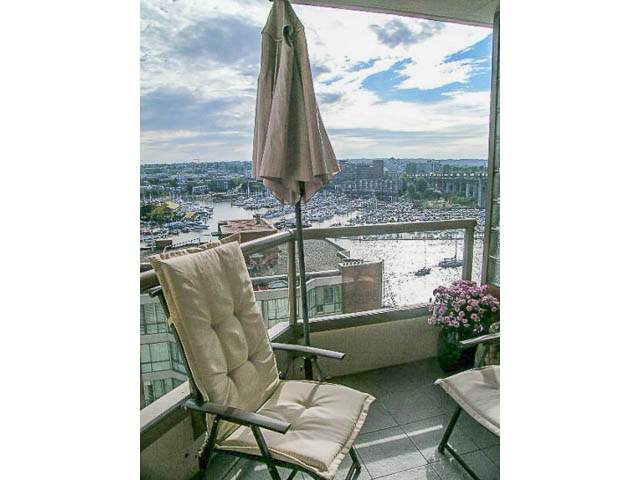 Furnished balcony with city view, patio furniture, and umbrella. - 1402 - 1625 Hornby, Vancouver Downtown