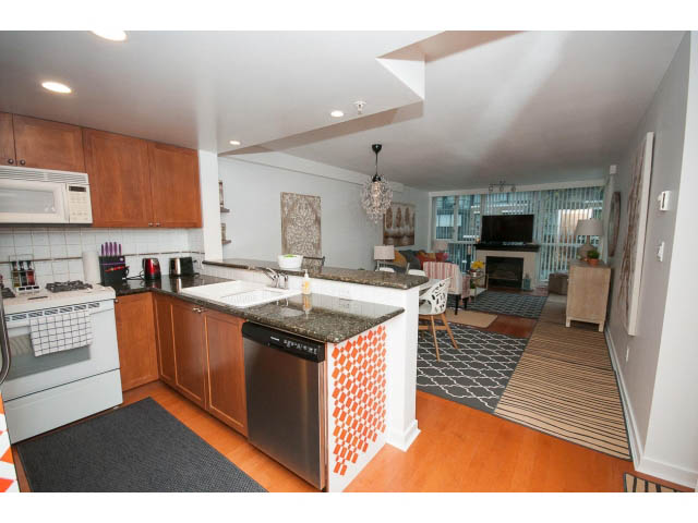 Bright kitchen with granite countertops, hardwood floors, and a city view. - 407 - 1485 West 6th Ave, Vancouver West Side