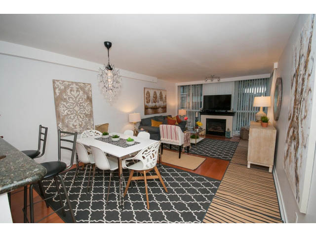 Open-concept living area with modern decor, hardwood floors, and a stylish chandelier. - 407 - 1485 West 6th Ave, Vancouver West Side