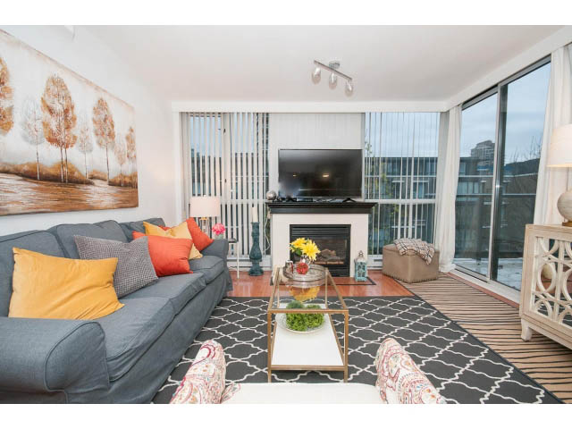 Furnished living room with a patterned rug, modern furniture, and a city view. - 407 - 1485 West 6th Ave, Vancouver West Side