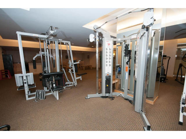Fitness room with various exercise machines and mirrors. - 407 - 1485 West 6th Ave, Vancouver West Side