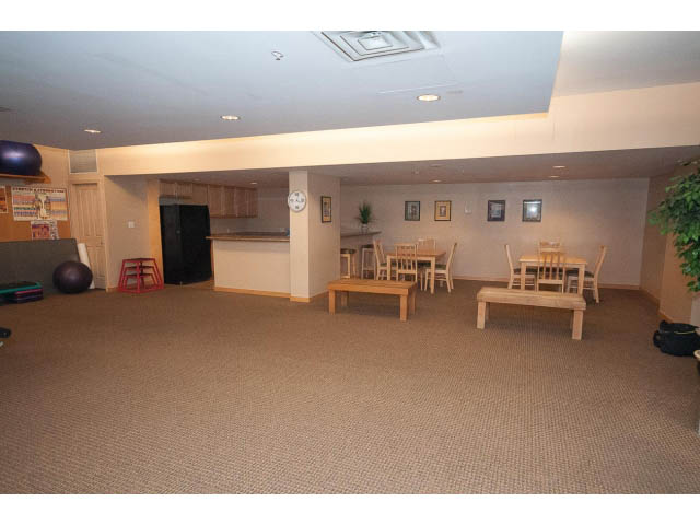 Spacious living room with hardwood floors, kitchen counter, and wall art. - 407 - 1485 West 6th Ave, Vancouver West Side