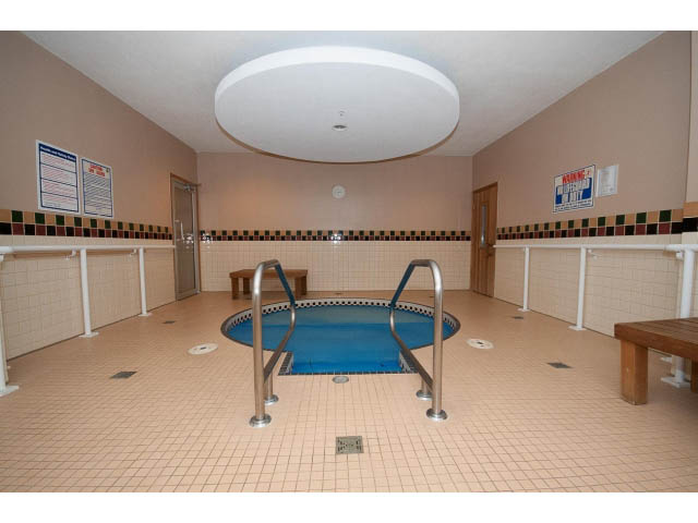 Spacious indoor pool area with tiled floors and railings. - 407 - 1485 West 6th Ave, Vancouver West Side