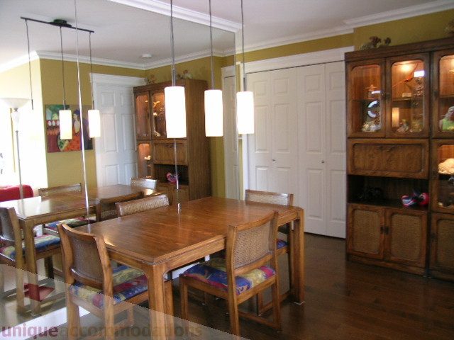 Furnished dining area with wooden table, chairs, and pendant lights; hardwood floors. - 7 - 1234 W 7th Ave., Vancouver West Side