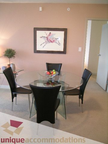 Dining area with modern chairs and glass table, artwork on wall. - 3101 - 1408 Strathmore Mews, Vancouver Downtown