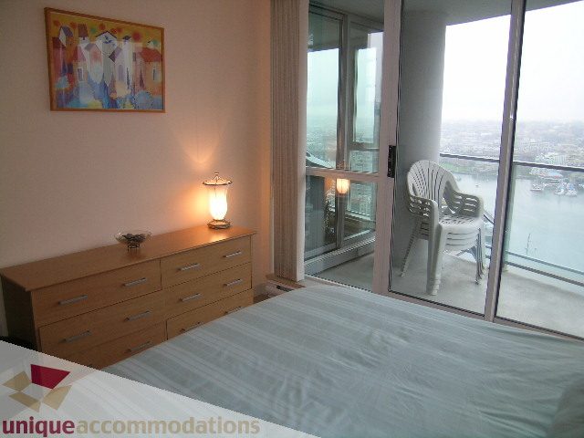 Furnished bedroom with city view and modern decor. - 3101 - 1408 Strathmore Mews, Vancouver Downtown
