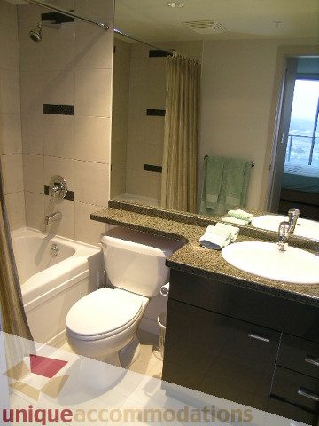 Bathroom with granite countertops, modern sink, and a view of the city. - 3101 - 1408 Strathmore Mews, Vancouver Downtown