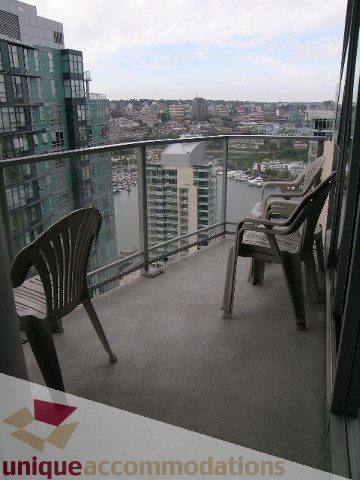 Furnished balcony with city view and outdoor seating. - 3101 - 1408 Strathmore Mews, Vancouver Downtown