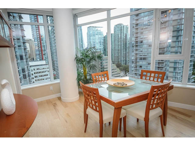 Furnished dining area with hardwood floors, city view, and modern decor. - 1604 - 1233 West Cordova Street, Vancouver Downtown