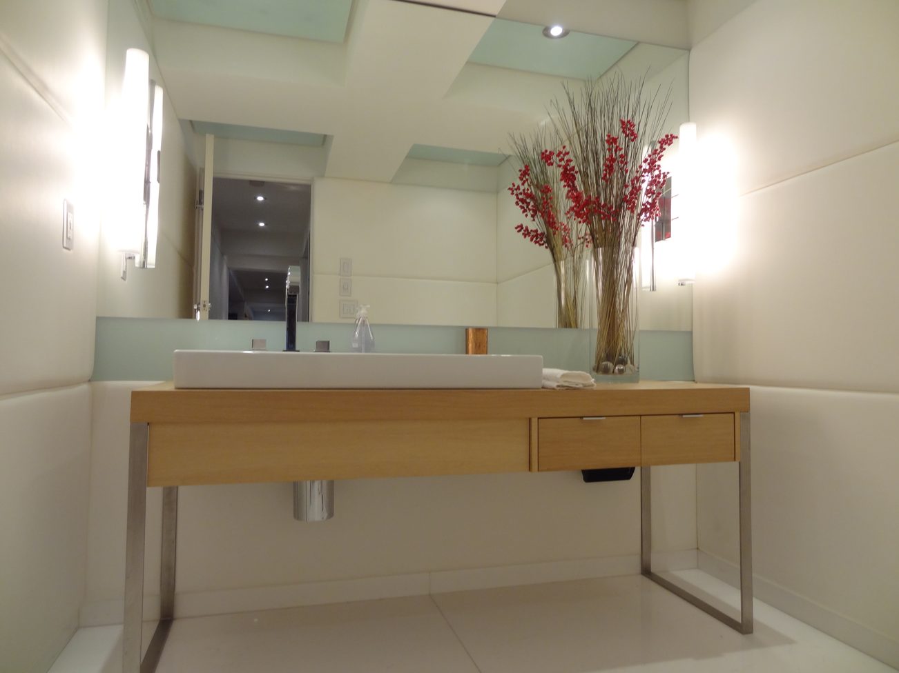 Modern bathroom with floating vanity, frosted glass back, and decorative vase. - 2898 Bellevue Avenue, West Vancouver