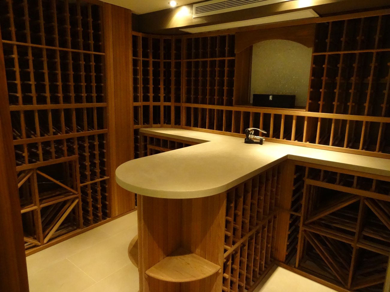 Wine cellar with curved counter and wooden racks. - 2898 Bellevue Avenue, West Vancouver