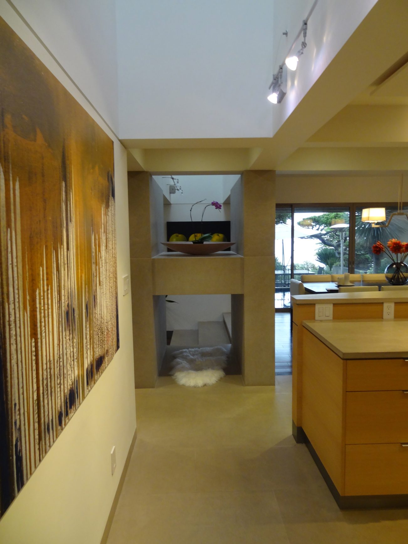 Bright kitchen with light wood cabinets, modern island, and view of outdoor greenery. - 2898 Bellevue Avenue, West Vancouver