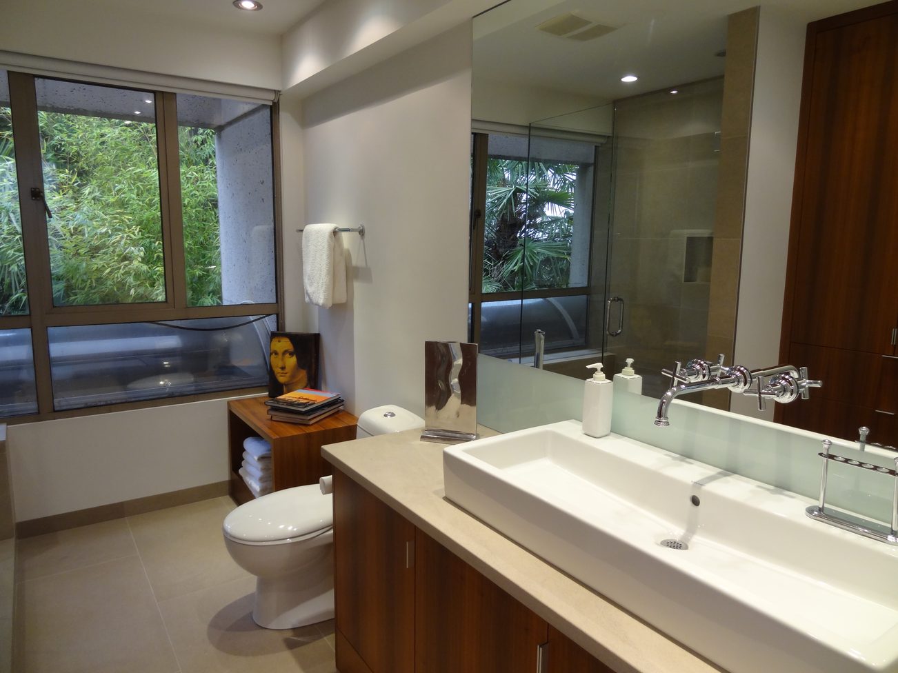 Spacious bathroom with dual sinks, large mirror, and view of greenery outside. - 2898 Bellevue Avenue, West Vancouver