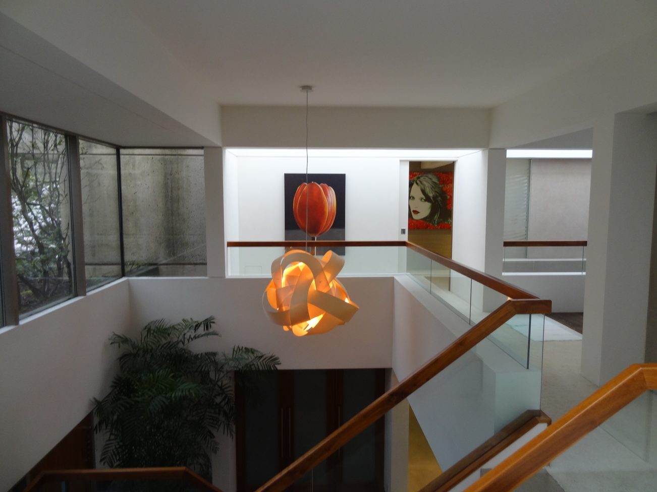 Staircase leading to upper level with modern art and glass railings. - 2898 Bellevue Avenue, West Vancouver