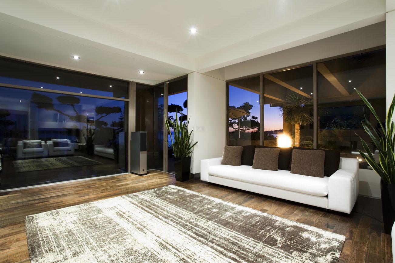 Modern living room with large windows, hardwood floors, and a city view. - 2898 Bellevue Avenue, West Vancouver