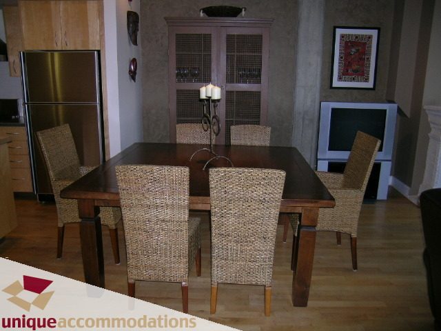 Furnished dining area with wicker chairs and wooden table, hardwood floors, and modern decor. - PH3  603 - 1155 Mainland, Vancouver Downtown