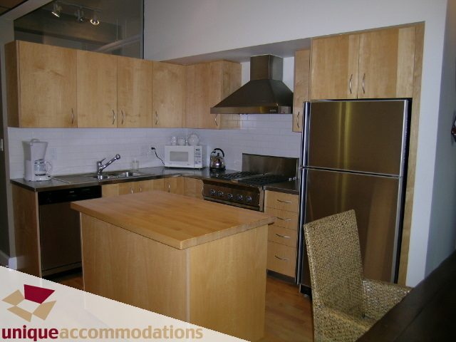 Bright kitchen with light wood cabinets, stainless steel appliances, and hardwood floors. - PH3  603 - 1155 Mainland, Vancouver Downtown