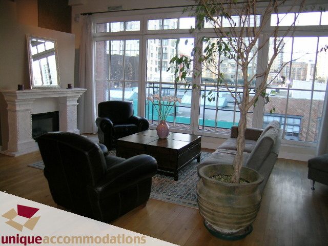 Furnished living room with hardwood floors, large windows, and a city view. - PH3  603 - 1155 Mainland, Vancouver Downtown