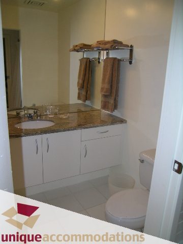 Furnished bathroom with granite countertop and towel rack. - PH3  603 - 1155 Mainland, Vancouver Downtown