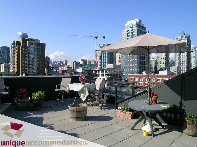 Furnished rooftop patio with city view, outdoor furniture, and potted plants. - PH3  603 - 1155 Mainland, Vancouver Downtown
