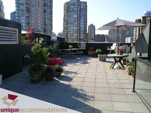 Furnished rooftop patio with city view, outdoor furniture, and potted plants. - PH3  603 - 1155 Mainland, Vancouver Downtown