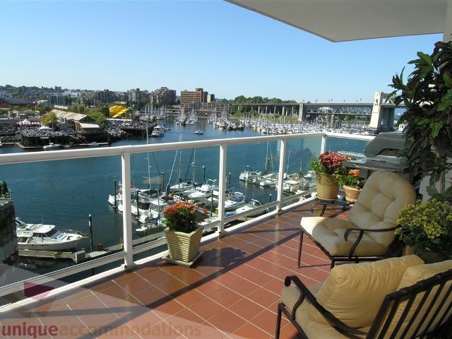Furnished balcony with city view and harbor boats, red-tiled floor, comfortable seating. - 706 - 1600 Howe Street, Vancouver Downtown