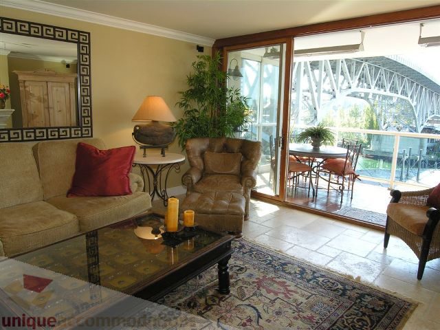 Bright living room with large windows, city view, and comfortable furniture. - 706 - 1600 Howe Street, Vancouver Downtown