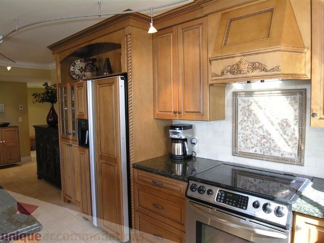 Bright kitchen with wooden cabinets, granite countertops, and stainless steel appliances. - 706 - 1600 Howe Street, Vancouver Downtown