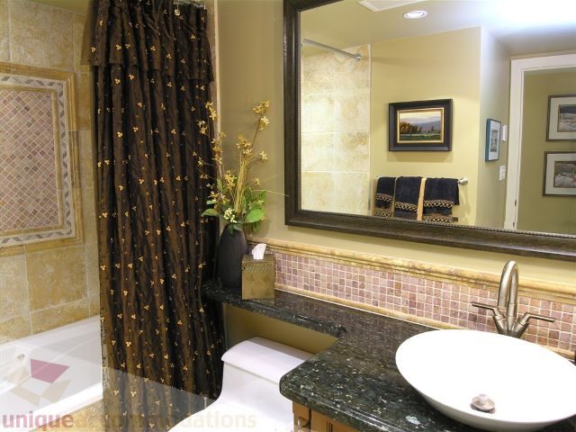 Furnished bathroom with granite countertops and a gold shower curtain. - 706 - 1600 Howe Street, Vancouver Downtown
