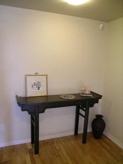 Spacious den with black countertop, wooden floor, and minimal decor. - 1035 Marinaside Crescent, Vancouver Downtown