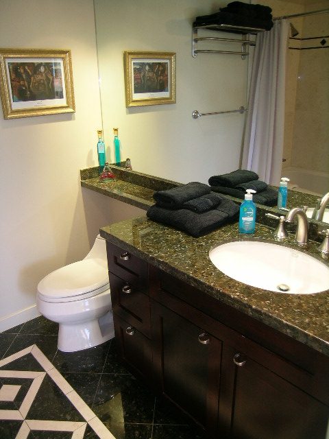 Bathroom with granite countertops, dark wood cabinets, and neatly folded towels. - 1035 Marinaside Crescent, Vancouver Downtown
