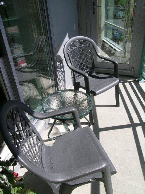 Furnished patio with outdoor seating and glass table, perfect for relaxing. - 1035 Marinaside Crescent, Vancouver Downtown